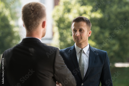 Two Businessman Shaking Hands Greeting Each Other