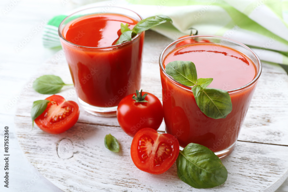 Glasses of fresh tomato juice on wooden table, closeup Glasses of fresh tomato juice on wooden table, closeup