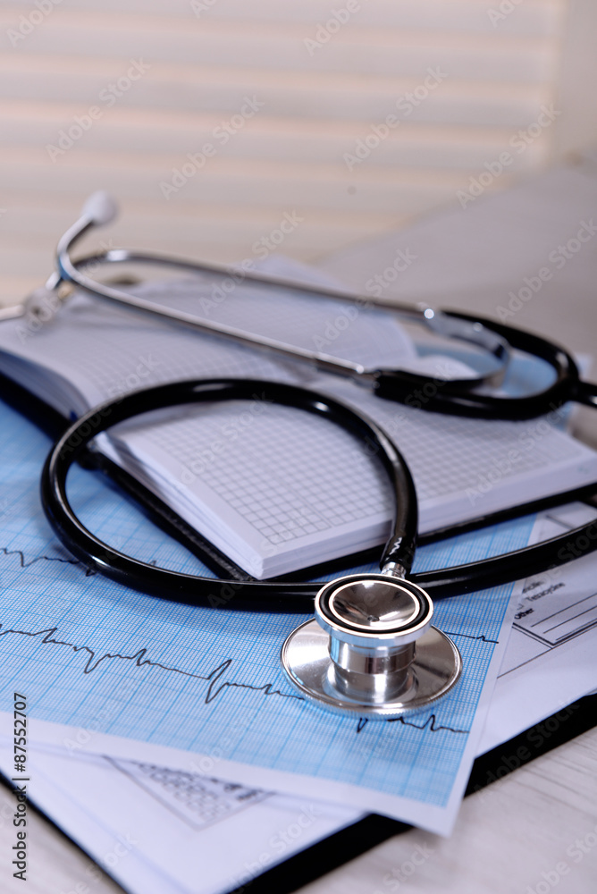 Cardiogram with stethoscope on table, closeup Cardiogram with stethoscope on table, closeup