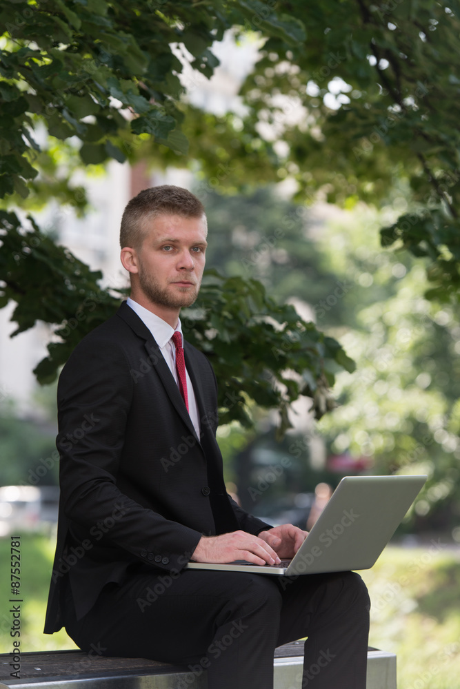 Young Man Working On Tablet Outside The Office Young Man Working On Tablet Outside The Office