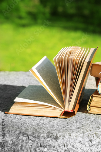 Stack of books outdoors, on blurred background