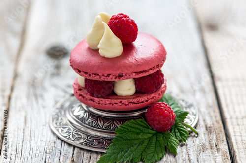 Macaroon with ripe raspberries.