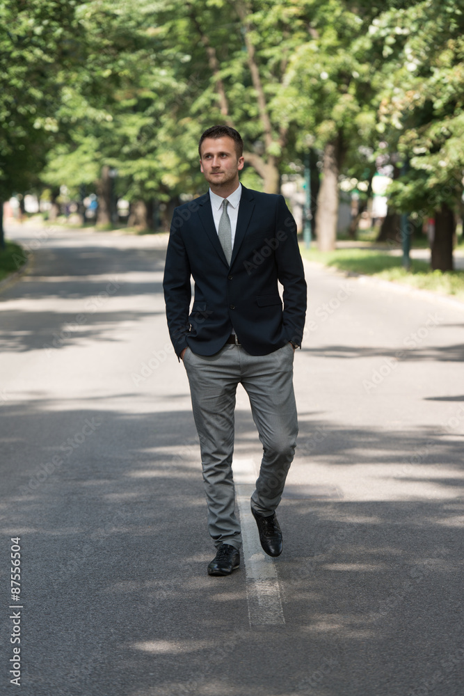 Young Business Man Walking Outdoors In Park Young Business Man Walking Outdoors In Park