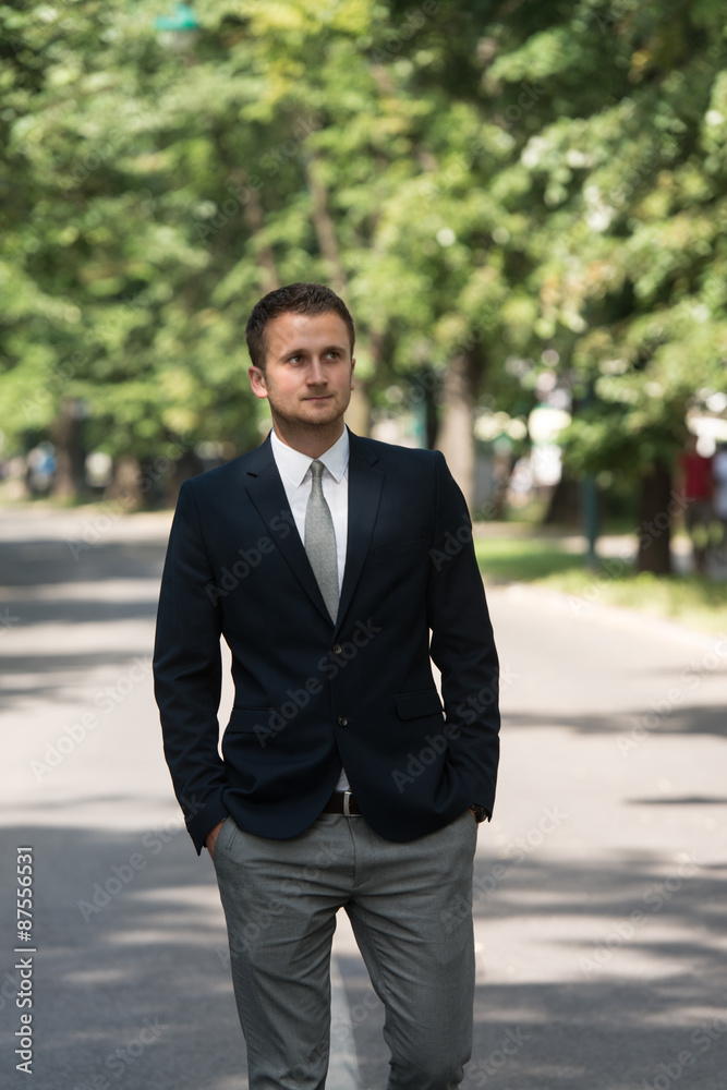 Young Business Man Walking Outdoors In Park Young Business Man Walking Outdoors In Park