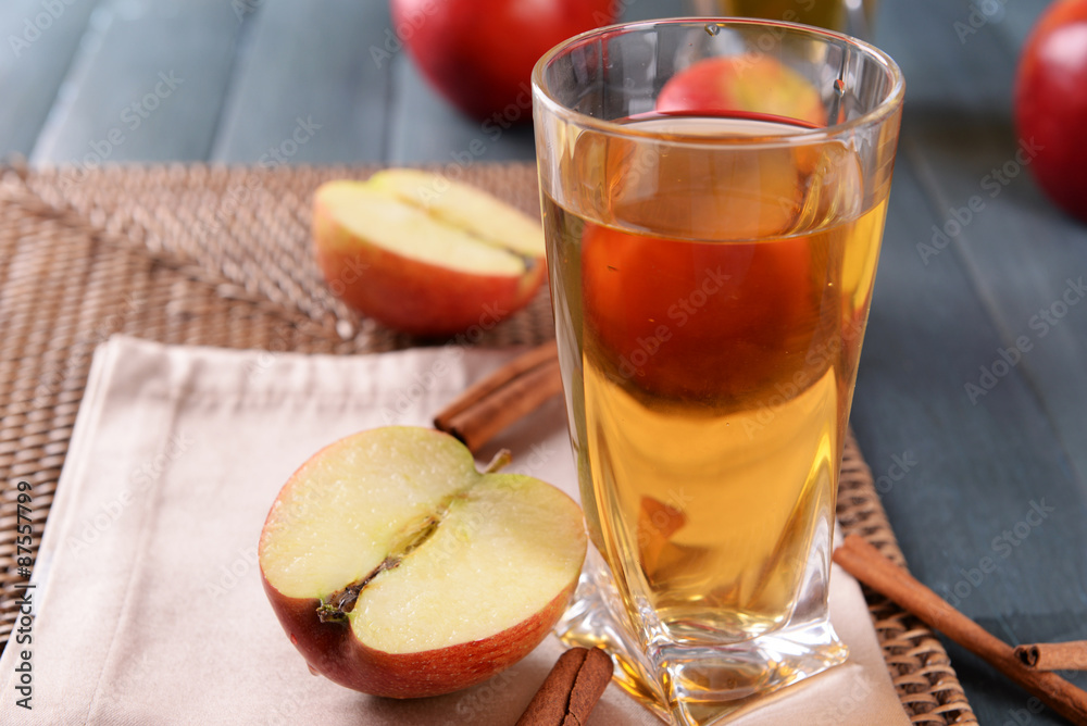 Glass of apple juice on wooden table, closeup Glass of apple juice on wooden table, closeup