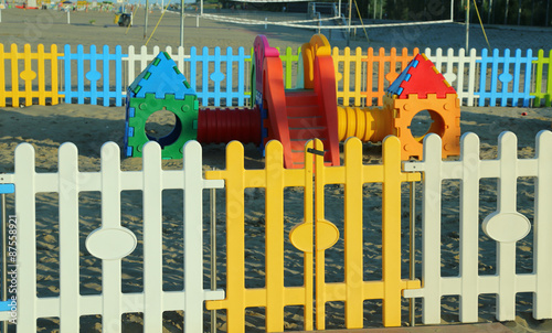 colorful fence of a playground on the beach in summer © ChiccoDodiFC