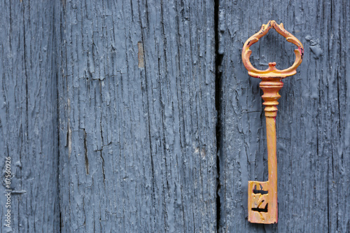 Old key on wooden antique door close-up