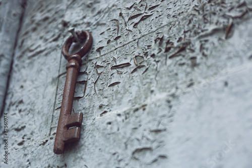 Old key on wooden antique door close-up © Africa Studio