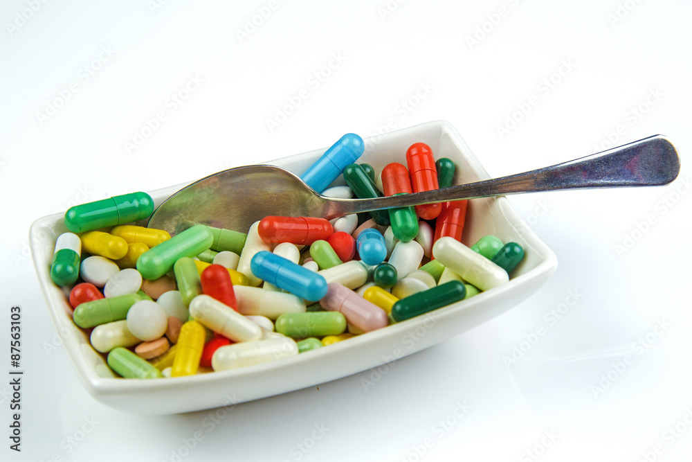 Lots of colorful pills on white background Lots of colorful pills on white background