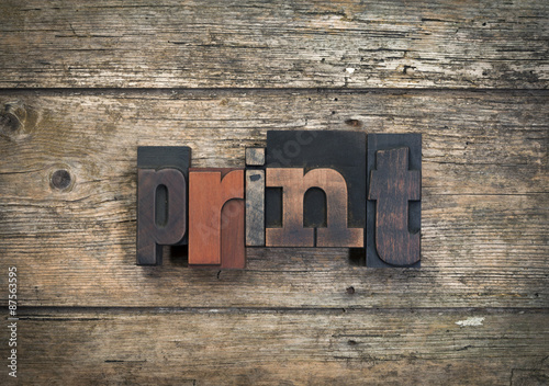 print, word written with vintage letterpress printing blocks on rustic wood background