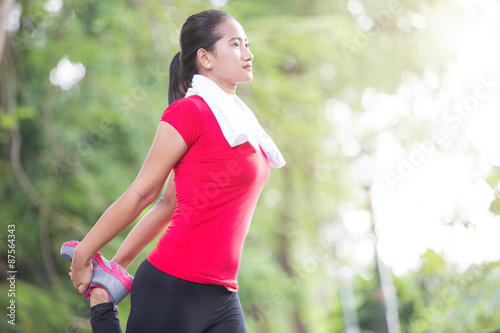 Asian woman doing stretching exercise during outdoor cross train
