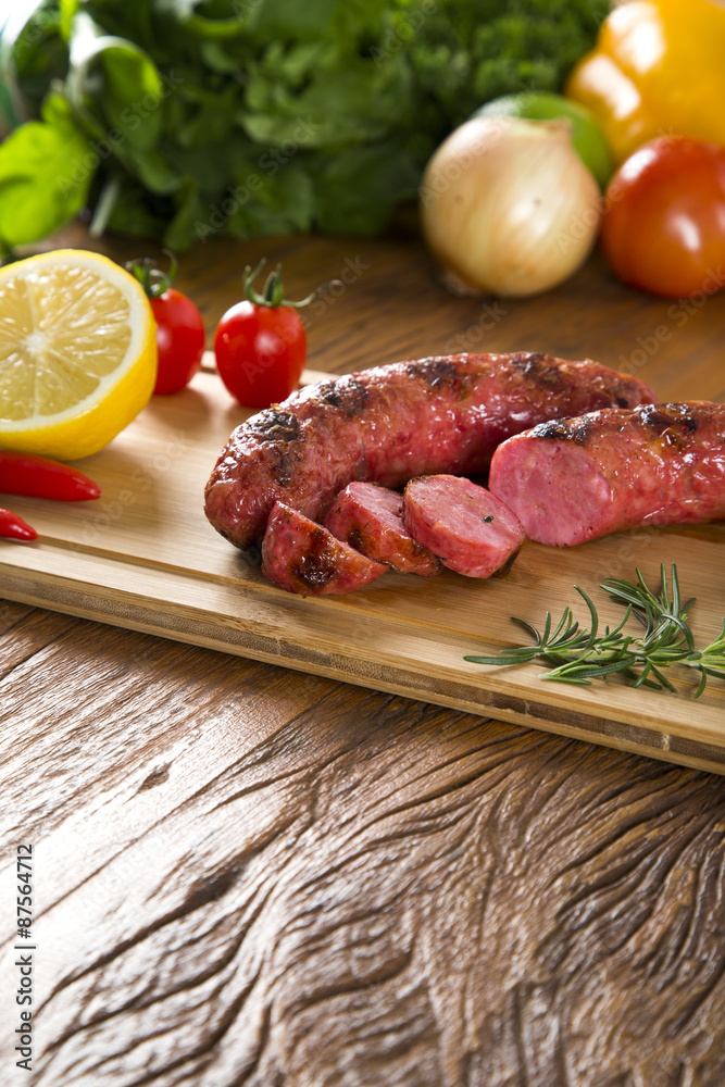 grilled meat sausages with potatoes and tomatoes