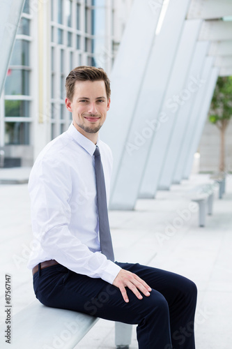 Принти на полотні Caucasian businessman sitting on blench at outdoor