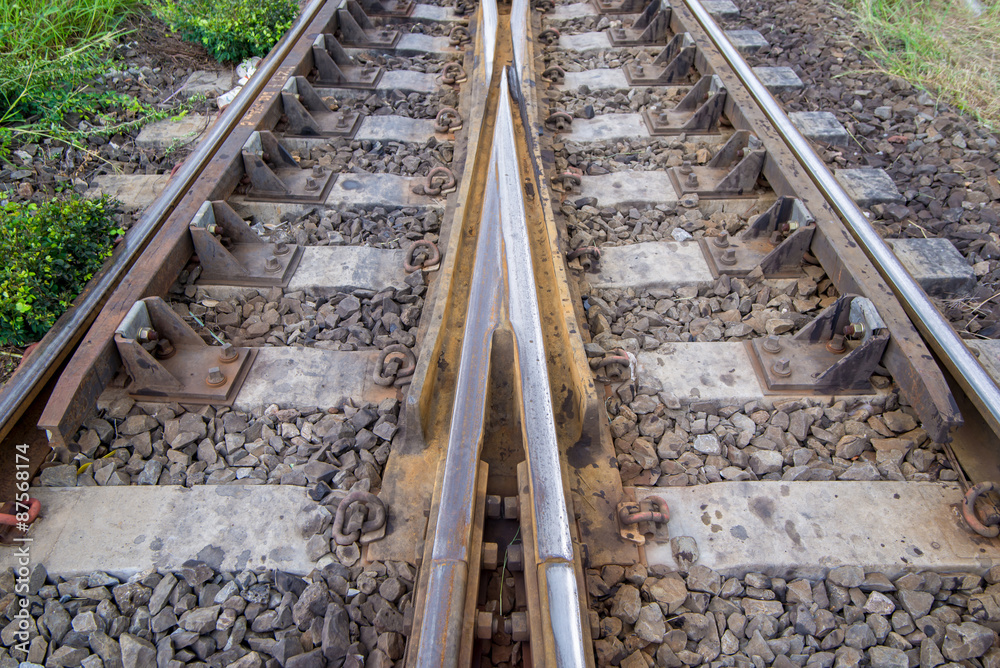 Fototapeta premium railroad tracks with railroad switch, two paths come together