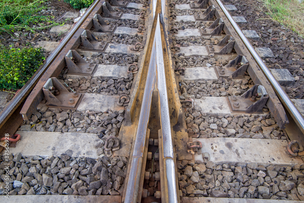 railroad tracks with railroad switch, two paths come together
