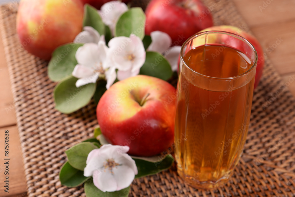 Glass of apple juice and apples on wooden table Glass of apple juice and apples on wooden table