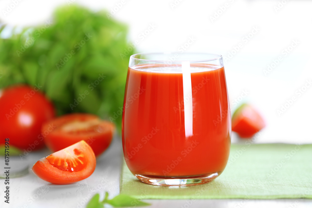 Tomato juice and fresh tomatoes on wooden table close-up Tomato juice and fresh tomatoes on wooden table close-up