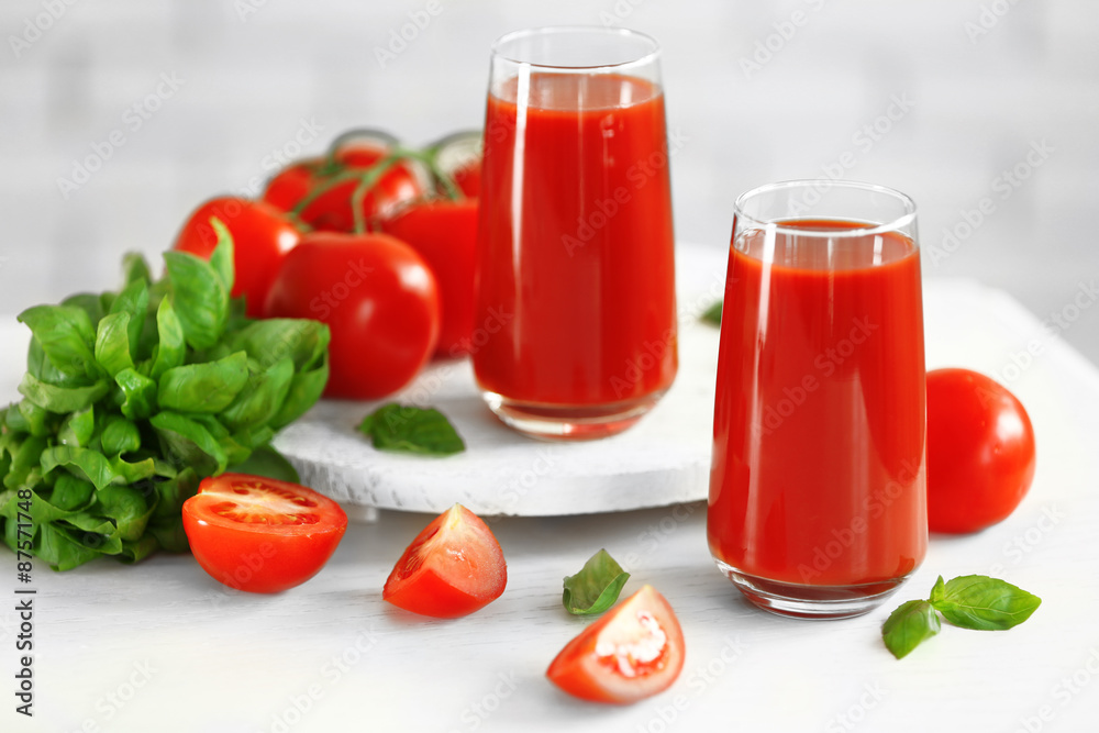 Tomato juice and fresh tomatoes on wooden table close-up Tomato juice and fresh tomatoes on wooden table close-up