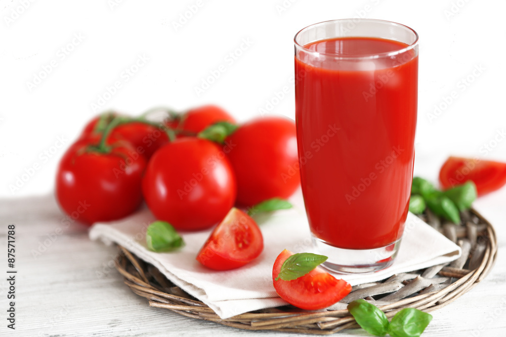 Tomato juice and fresh tomatoes on wooden table close-up Tomato juice and fresh tomatoes on wooden table close-up