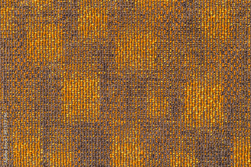 Surface of the grayish orange carpet.