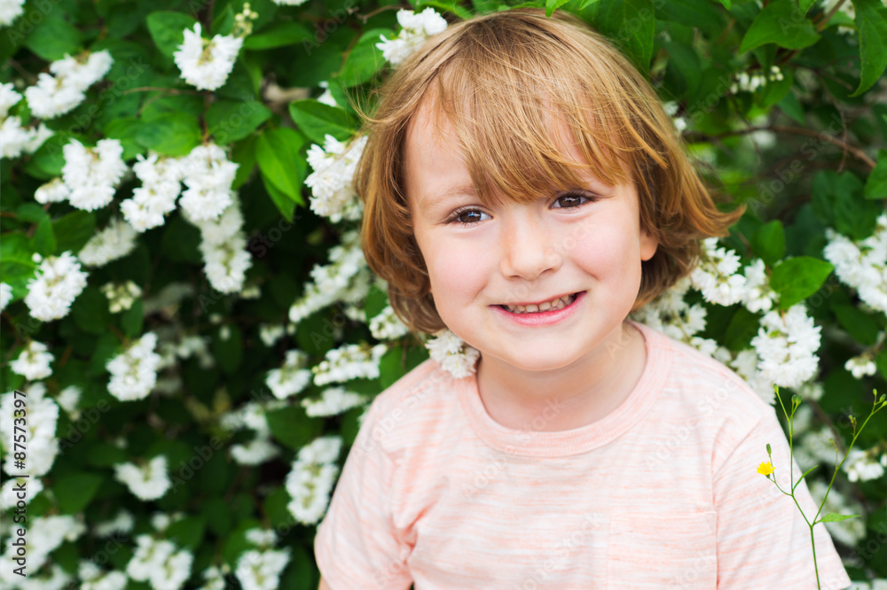Outdoor close up portrait of adorable little blond boy of 4 years old with hairstyle and sweet smile on his face Outdoor close up portrait of adorable little blond boy of 4 years old with hairstyle and sweet smile on his face