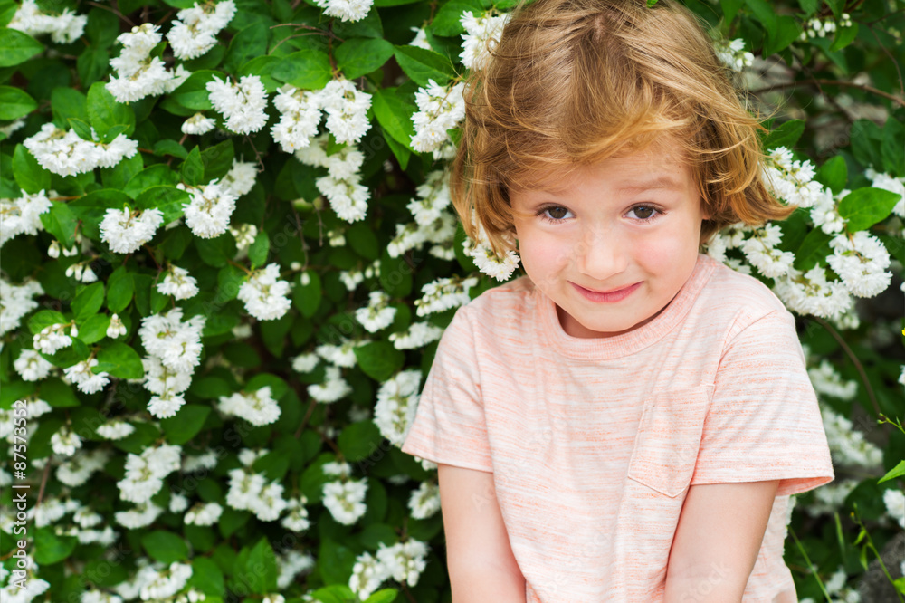 Outdoor close up portrait of adorable little blond boy of 4 years old with hairstyle and sweet smile on his face Outdoor close up portrait of adorable little blond boy of 4 years old with hairstyle and sweet smile on his face