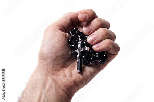 Hand holding wooden rosary with Catholic crucifix