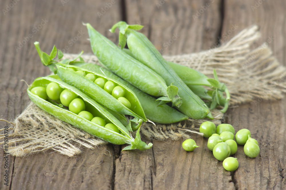 green peas on wooden background green peas on wooden background