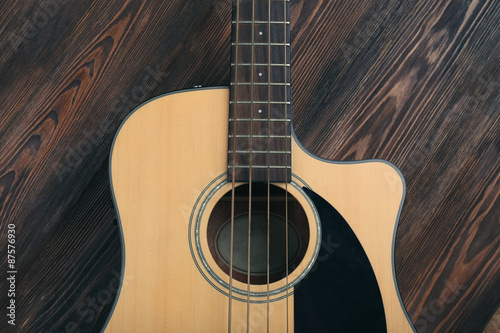 Acoustic guitar on wooden background