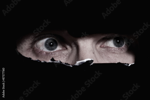 Scary eyes of a man spying