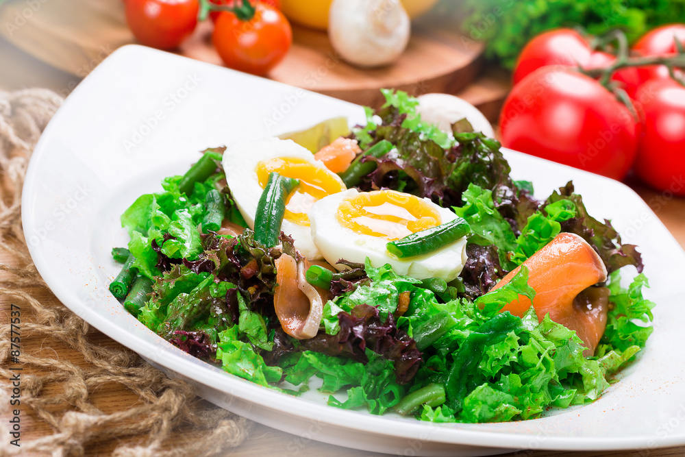 Fresh green salad with salmon and eggs