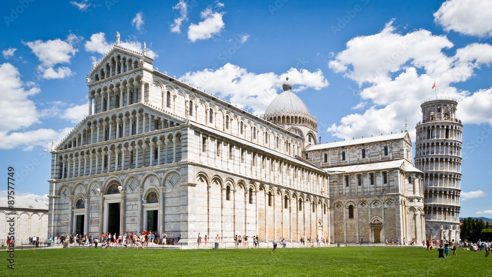 Piazza dei Miracoli, Pisa, Italy. The facade to Pisa cathedral with the famous leaning tower in the background.