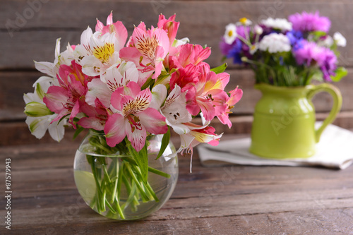 Wallpaper Mural Beautiful flowers in vases on table close up Torontodigital.ca