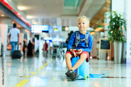 cute little boy waiting in the airport