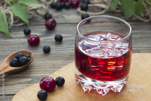 cherry juice with berries on the table