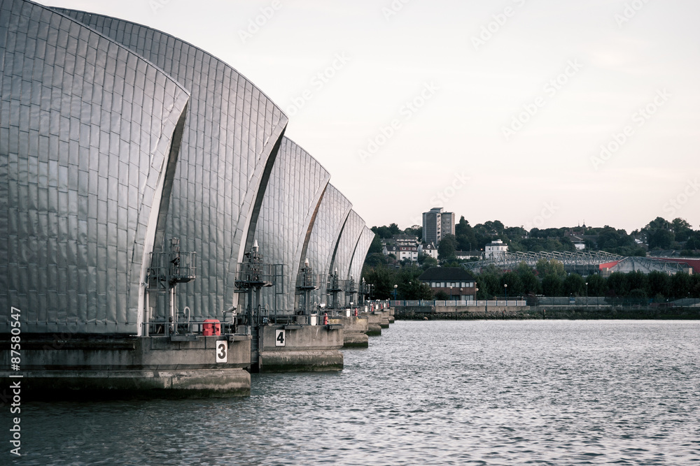 Thames Flood Barrier, London. A view along the Thames flood barrier which runs across the river in East London.