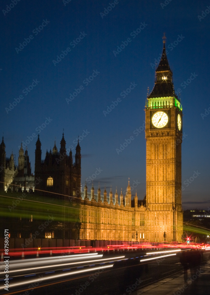 Big Ben, London. Long exposure, night view of the iconic London landmark with traffic streaming by.