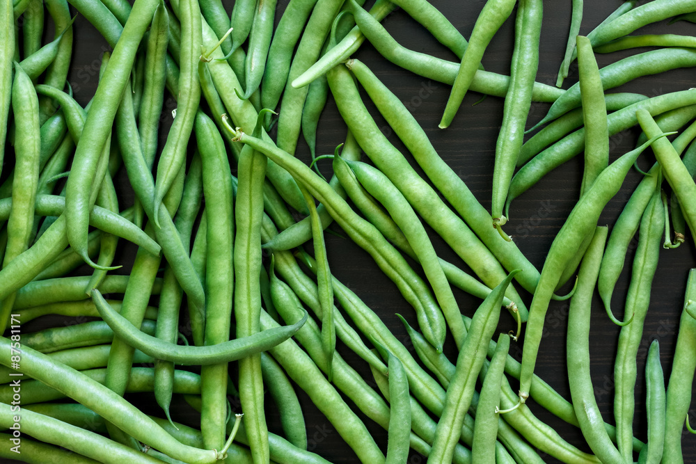 Whole French green string beans on black rustic surface. Whole French green string beans on black rustic surface.