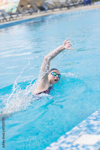 Woman in goggles swimming front crawl style © mr.markin