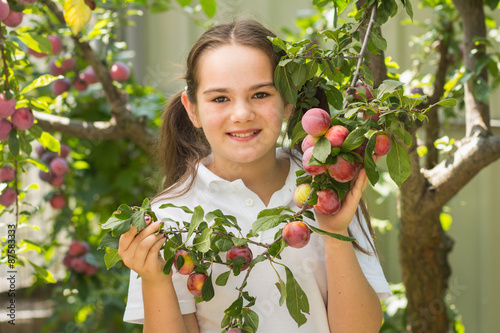 little girl holding plum