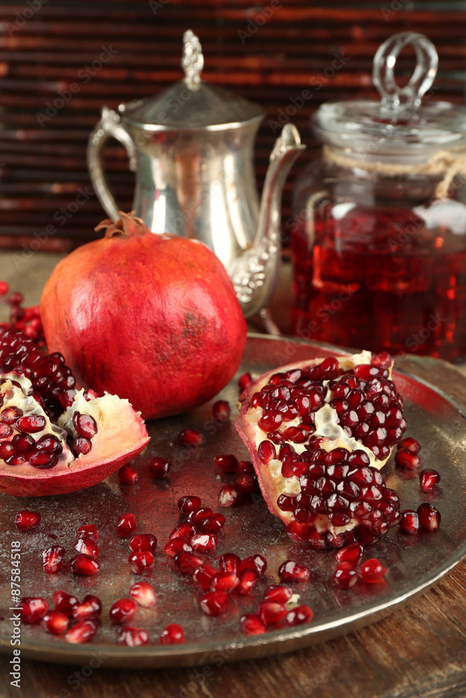 Pomegranate seeds and juice on table, closeup Pomegranate seeds and juice on table, closeup