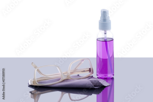 Pair of eyeglasses and cleaner photo