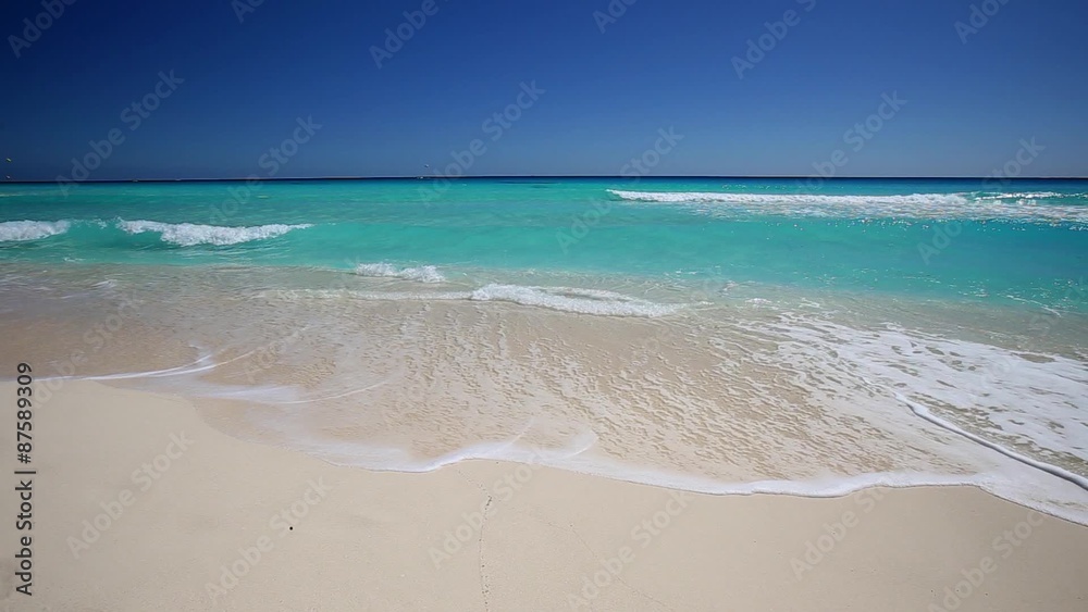 Surfing sea waves with foam on white tropical sandy beach
Surfing sea waves with foam on white tropical sandy beach