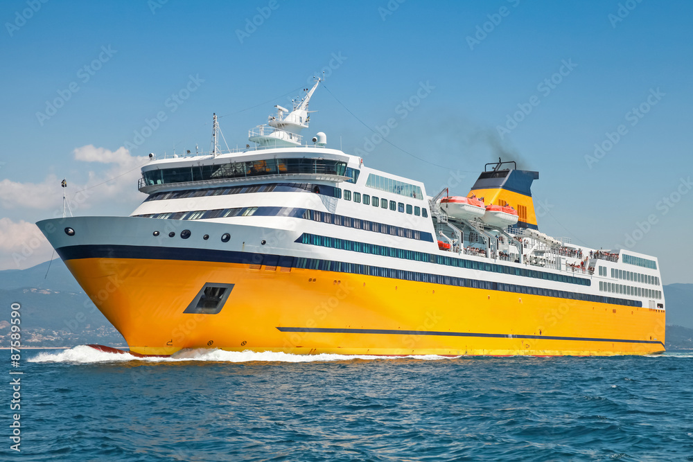 Big yellow passenger ferry goes on the Sea