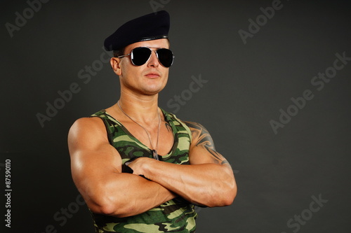 Portrait of young military man at sunglasses, right you can write some text