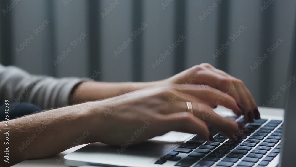Work with a  laptop typeing on a keyboard