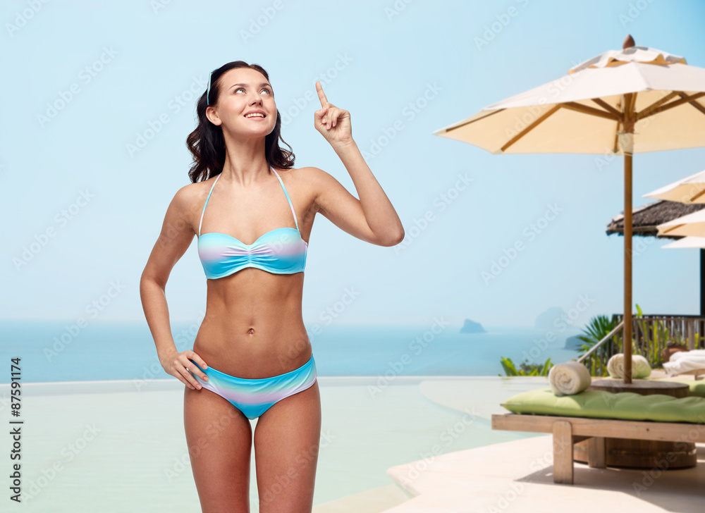 happy woman in bikini swimsuit pointing finger up