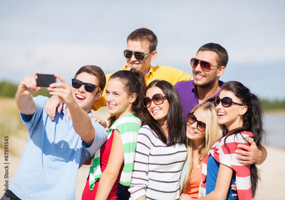 group of friends taking selfie with cell phone group of friends taking selfie with cell phone