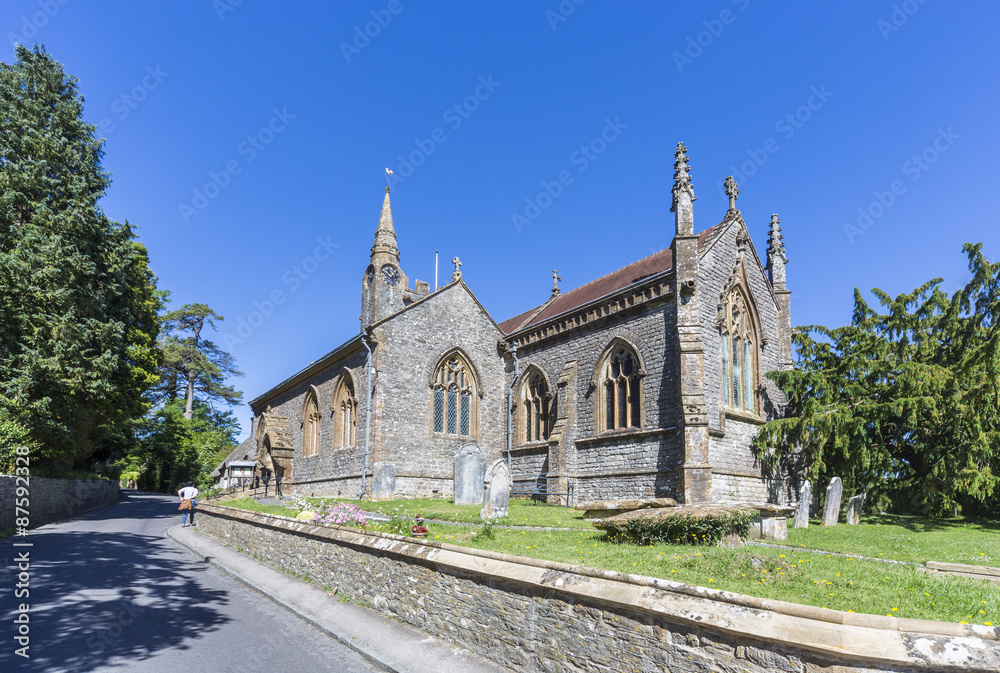 Church of St Osmund in Evershot, a small village in Dorset, southern England, in summer.  The church is a very attractive listed building built of stone in a typical local style