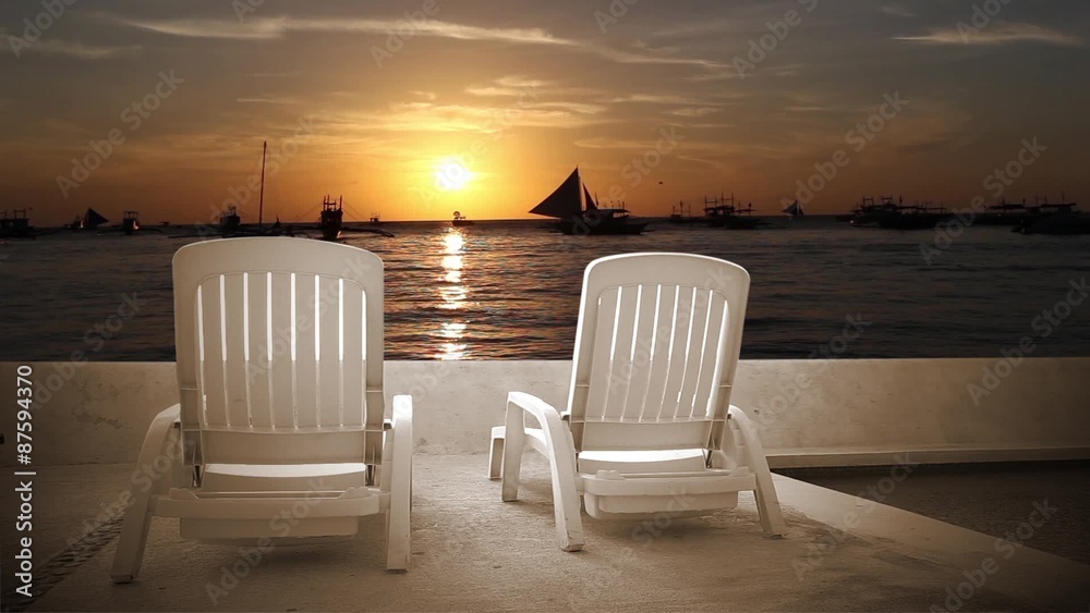 Sunbathing beds near swimming pool in sunset on tropical sea with sailboats.
Vacation concept Sunbathing beds near swimming pool in sunset on tropical sea with sailboats.
Vacation concept
